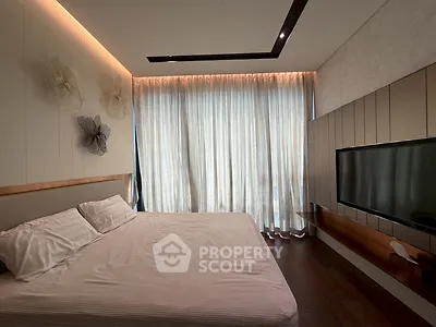 Luxurious bedroom with modern decor and large window for natural light