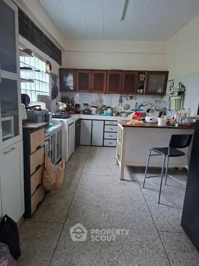 Spacious kitchen with closed layout and ample storage, featuring modern appliances and a cozy dining area.