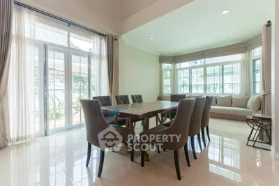 Spacious dining area with elegant seating and large windows offering natural light.