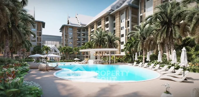 Luxurious tropical resort-style pool surrounded by lush greenery and elegant loungers, offering an oasis of relaxation in a high-end residential complex.