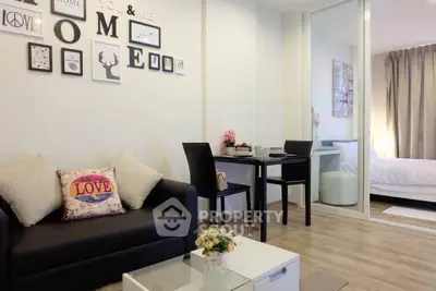 Modern living room with stylish decor and cozy bedroom in open layout apartment.