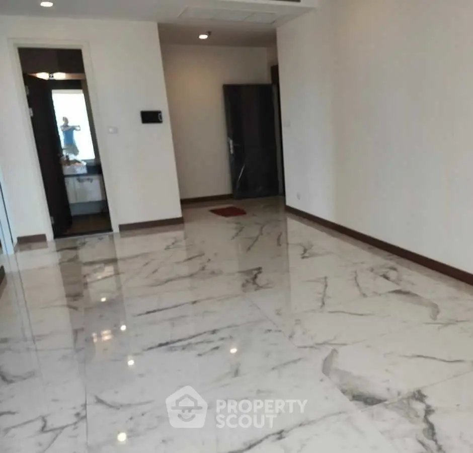 Spacious empty room with elegant marble flooring and modern design.