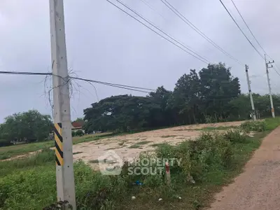 Spacious vacant land plot with lush greenery, ideal for development opportunities.