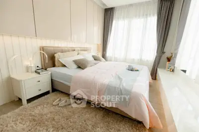 Luxurious bedroom with elegant decor and natural light, featuring plush bedding and stylish curtains.
