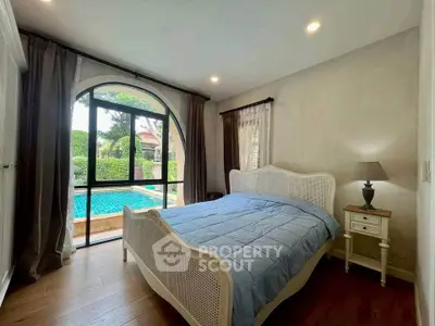 Charming bedroom with pool view and elegant furnishings
