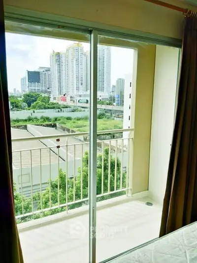 Bright balcony view with cityscape and greenery, perfect for urban living.