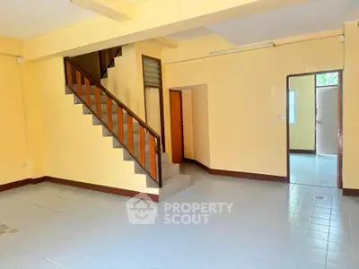 Spacious interior with staircase and tiled flooring, ideal for customization.
