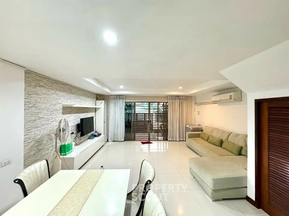 Spacious living room with modern decor and large windows for natural light