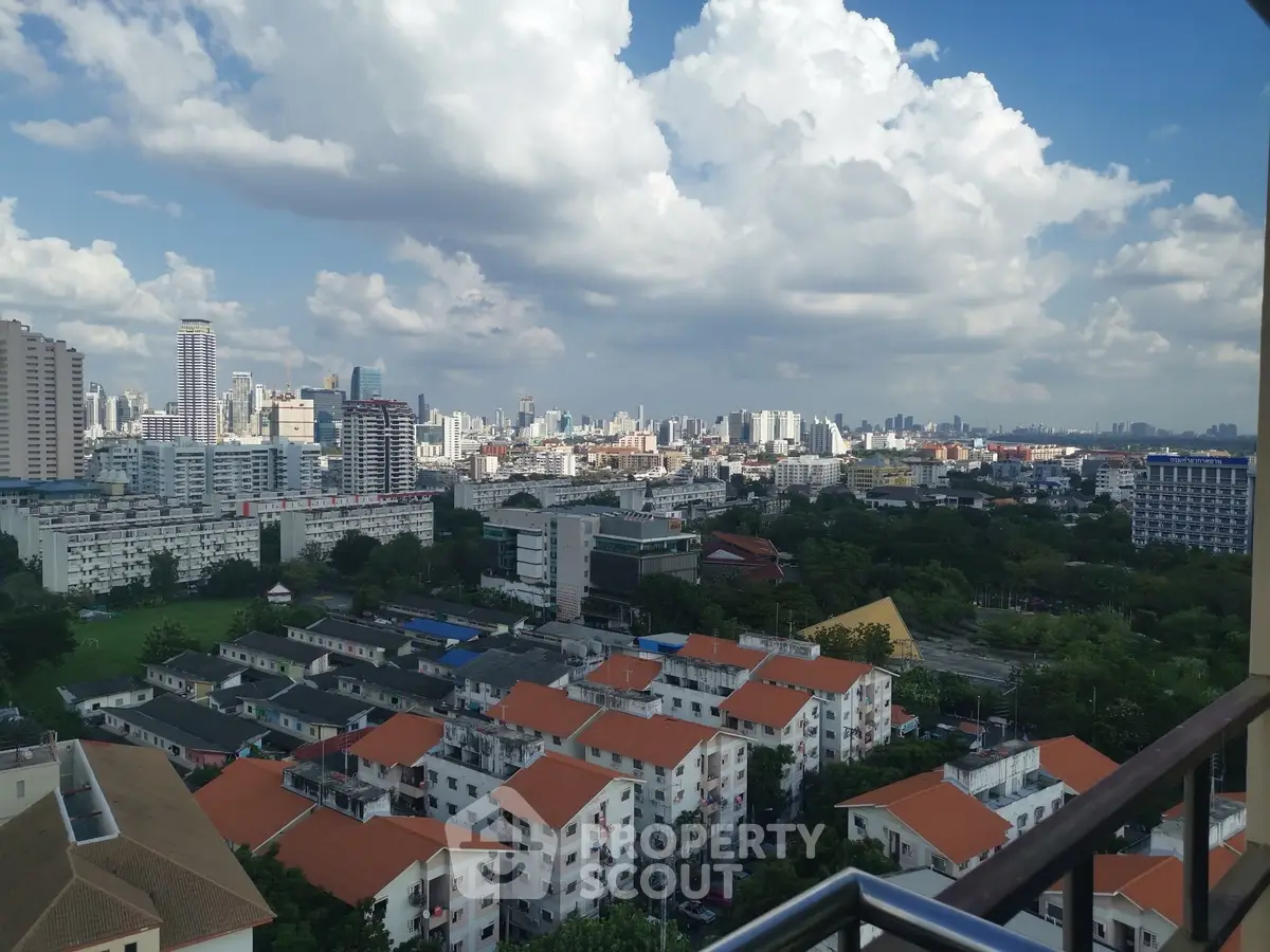 Stunning cityscape view from high-rise balcony showcasing vibrant urban skyline.