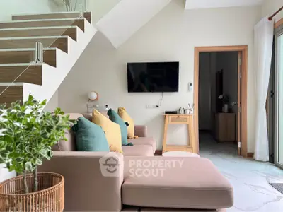 Modern living room with stylish staircase and cozy seating area