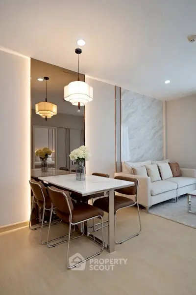 Modern living room with elegant dining area and stylish lighting in a contemporary apartment.