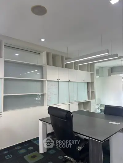 Modern office space with sleek furniture and ample storage, ideal for productivity and collaboration.