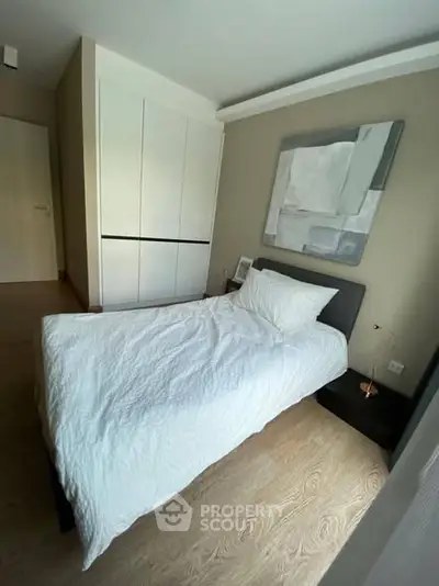 Modern bedroom with minimalist decor and cozy single bed in stylish apartment.