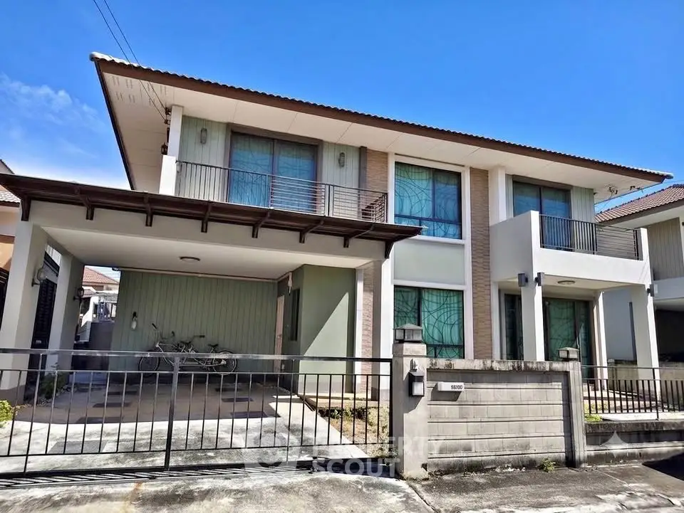Modern two-story house with spacious driveway and contemporary design.