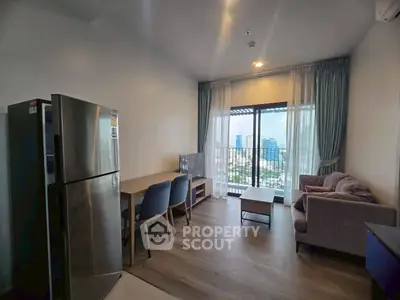 Modern living room with city view, stylish furniture, and natural light.