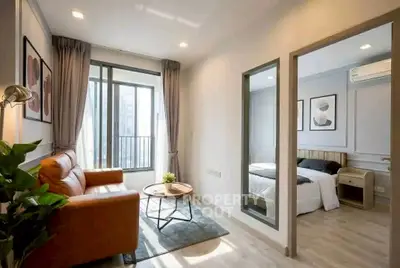 Modern apartment with cozy living room and stylish bedroom, featuring large windows and contemporary decor.