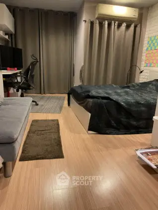 Cozy modern bedroom with workspace, featuring sleek furniture and warm lighting.