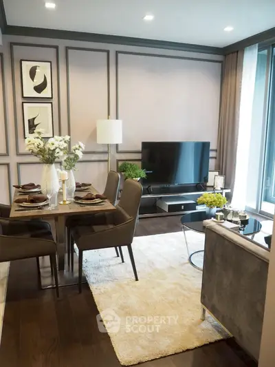 Elegant living room with modern decor, featuring a sleek TV setup and stylish dining area.