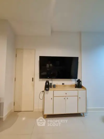 Modern living room with wall-mounted TV and stylish cabinet