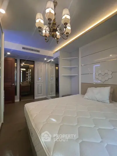Luxurious bedroom with elegant chandelier and modern design