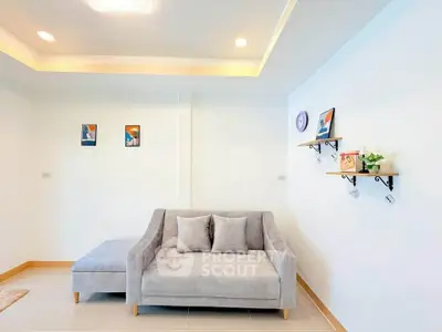 Modern living room with cozy gray sofa and minimalist decor