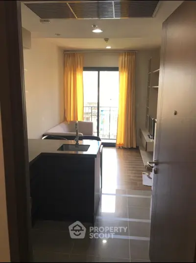 Modern apartment interior with open kitchen and balcony view