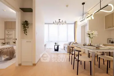 Modern open-plan living and dining area with stylish lighting and natural light.