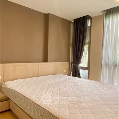 Spacious bedroom with large windows and modern decor