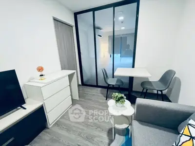 Modern living room with sleek furniture and glass partition, perfect for urban living.