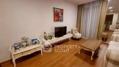Elegant living room with hardwood floors, stylish furniture, and large window for natural light.