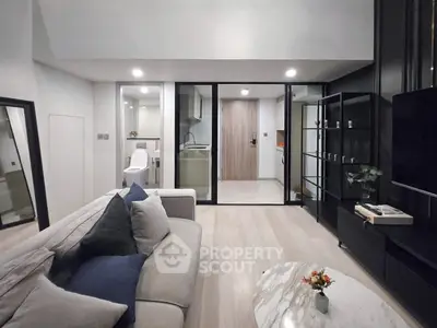Modern living room with open layout, stylish furniture, and sleek design elements.