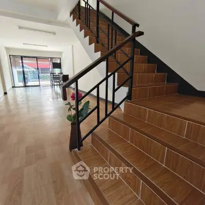 Spacious interior with wooden staircase and open layout, ideal for modern living.