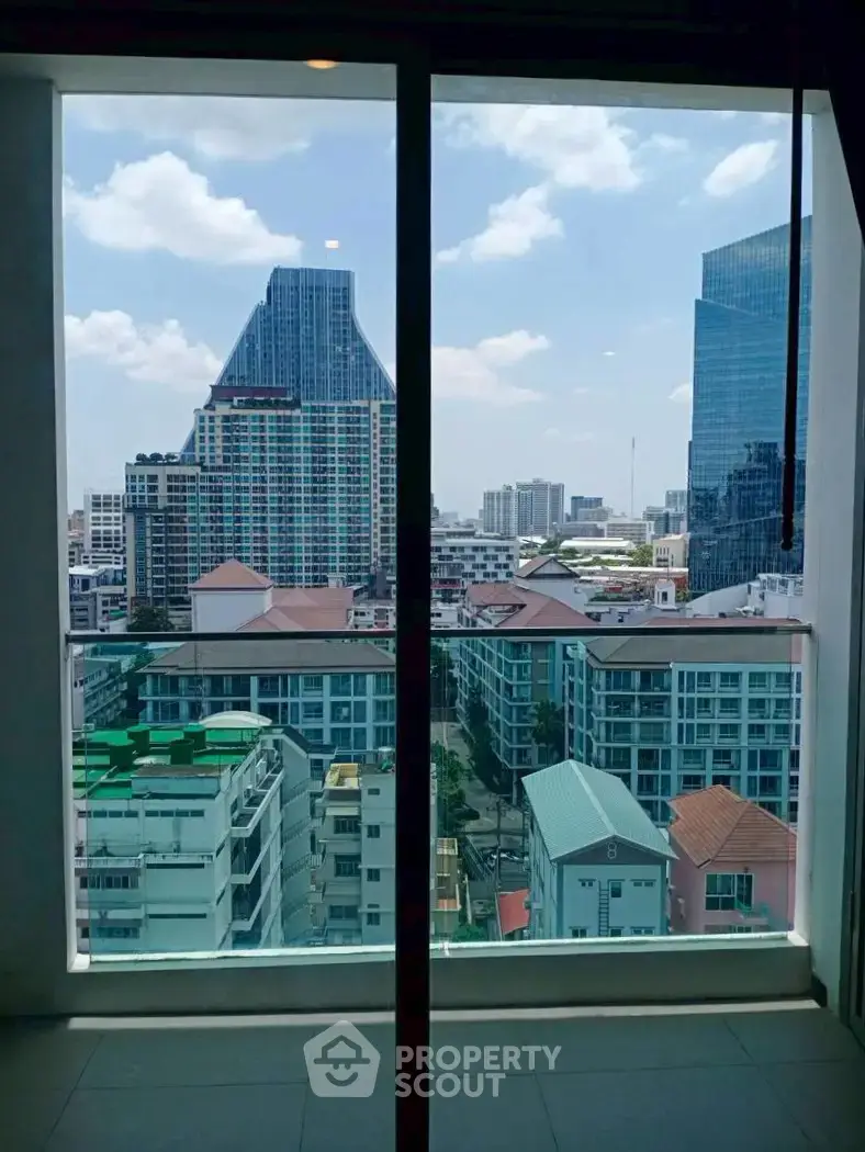 Stunning cityscape view from high-rise apartment window with modern skyline.