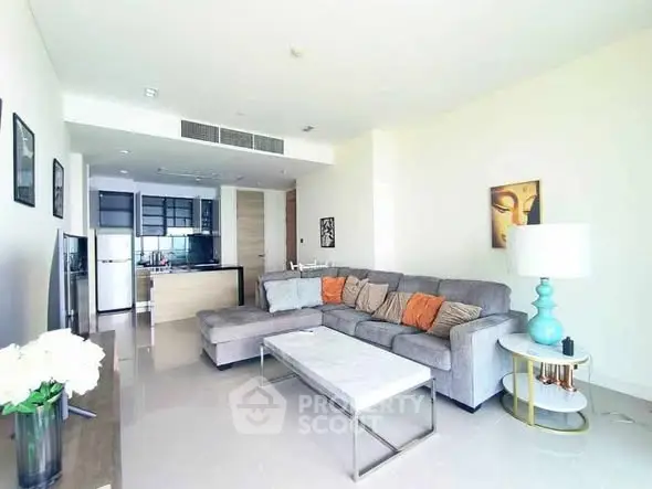 Spacious modern living room with sectional sofa and open kitchen layout