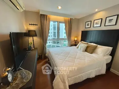 Cozy bedroom with elegant decor and large window offering city view