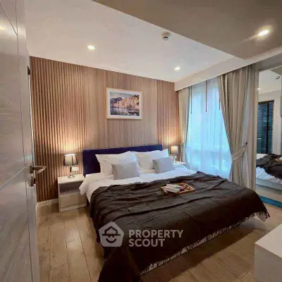 Luxurious bedroom with elegant decor and cozy ambiance, featuring a plush bed and stylish lighting.