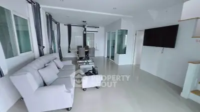 Spacious modern living room with elegant dining area and large windows