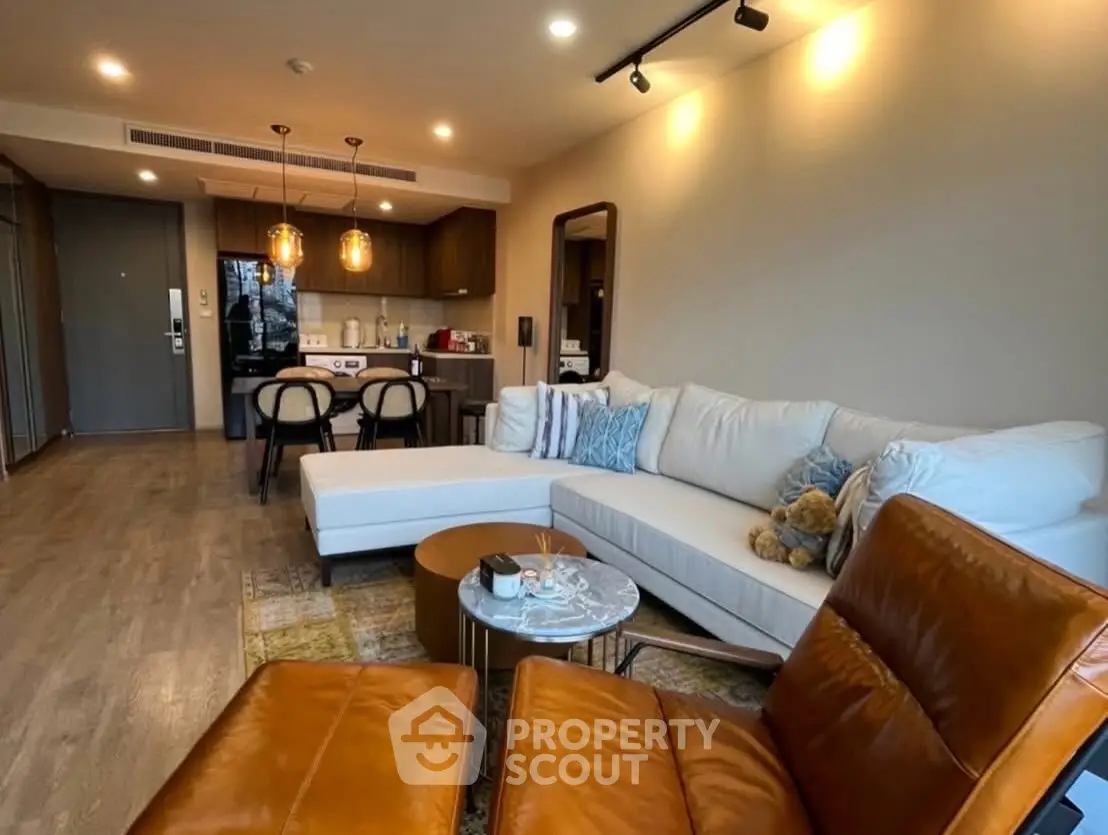 Modern living room with stylish furniture and open kitchen layout