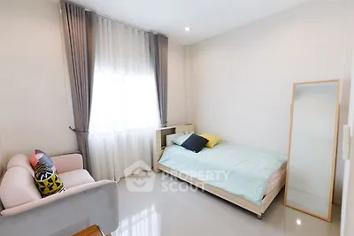 Bright and cozy bedroom with modern decor and natural light.