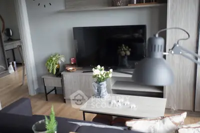 Modern living room with stylish decor and large TV