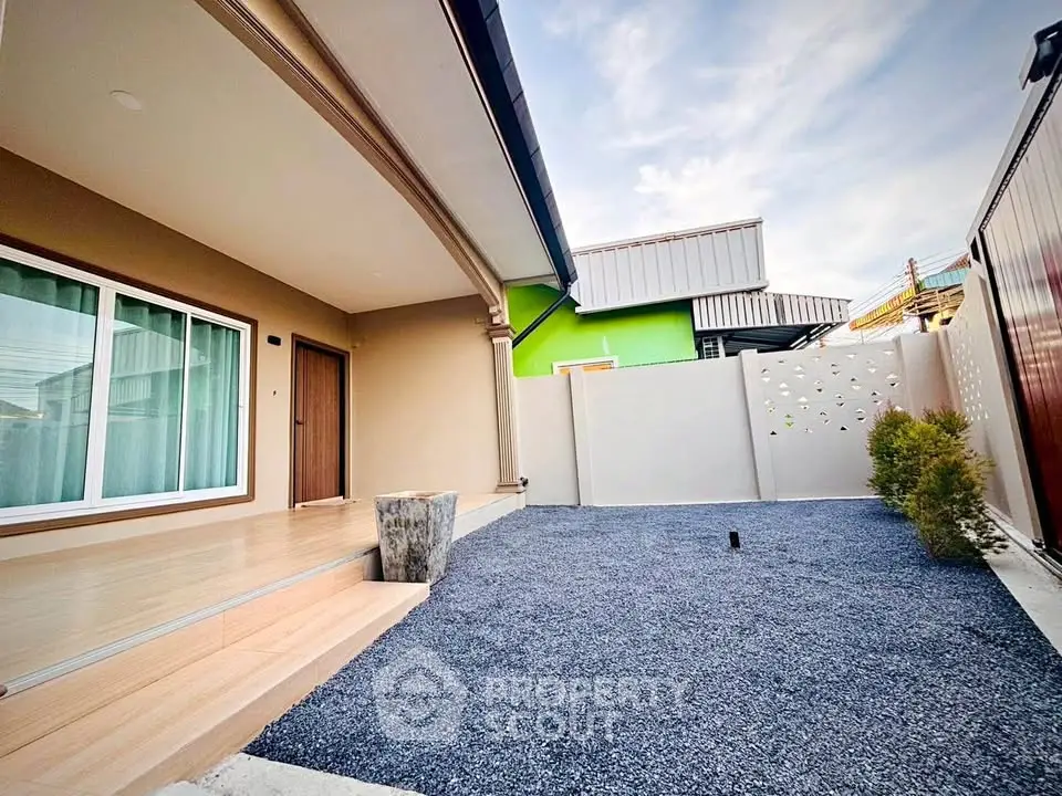 Modern home exterior with sleek design and spacious entrance area.