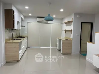Modern kitchen with sleek cabinetry and gas stove in open layout