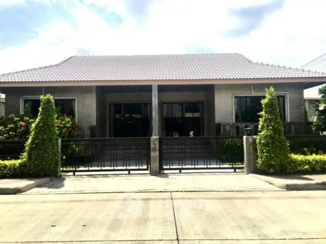 Charming single-story home with modern facade and lush landscaping.