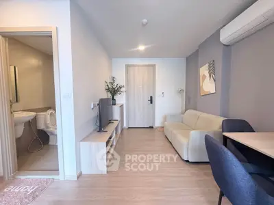 Modern living room with cozy sofa, TV, and air conditioning in a stylish apartment.