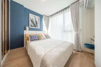 Modern bedroom with stylish decor and large windows for natural light