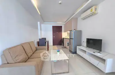 Modern living room with sleek furniture and compact kitchen area