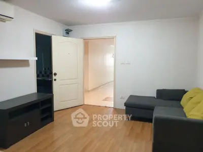 Spacious living room with modern sofa and wooden flooring, ideal for comfortable living.