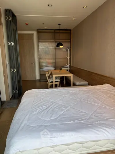 Modern bedroom with stylish dining area and wooden accents