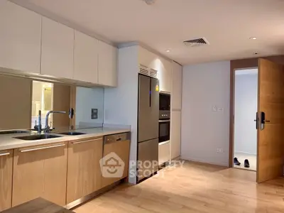Modern kitchen with sleek cabinetry and built-in appliances in a stylish apartment