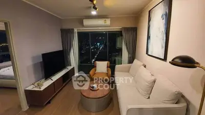 Modern living room with city view, featuring stylish furniture and elegant decor.